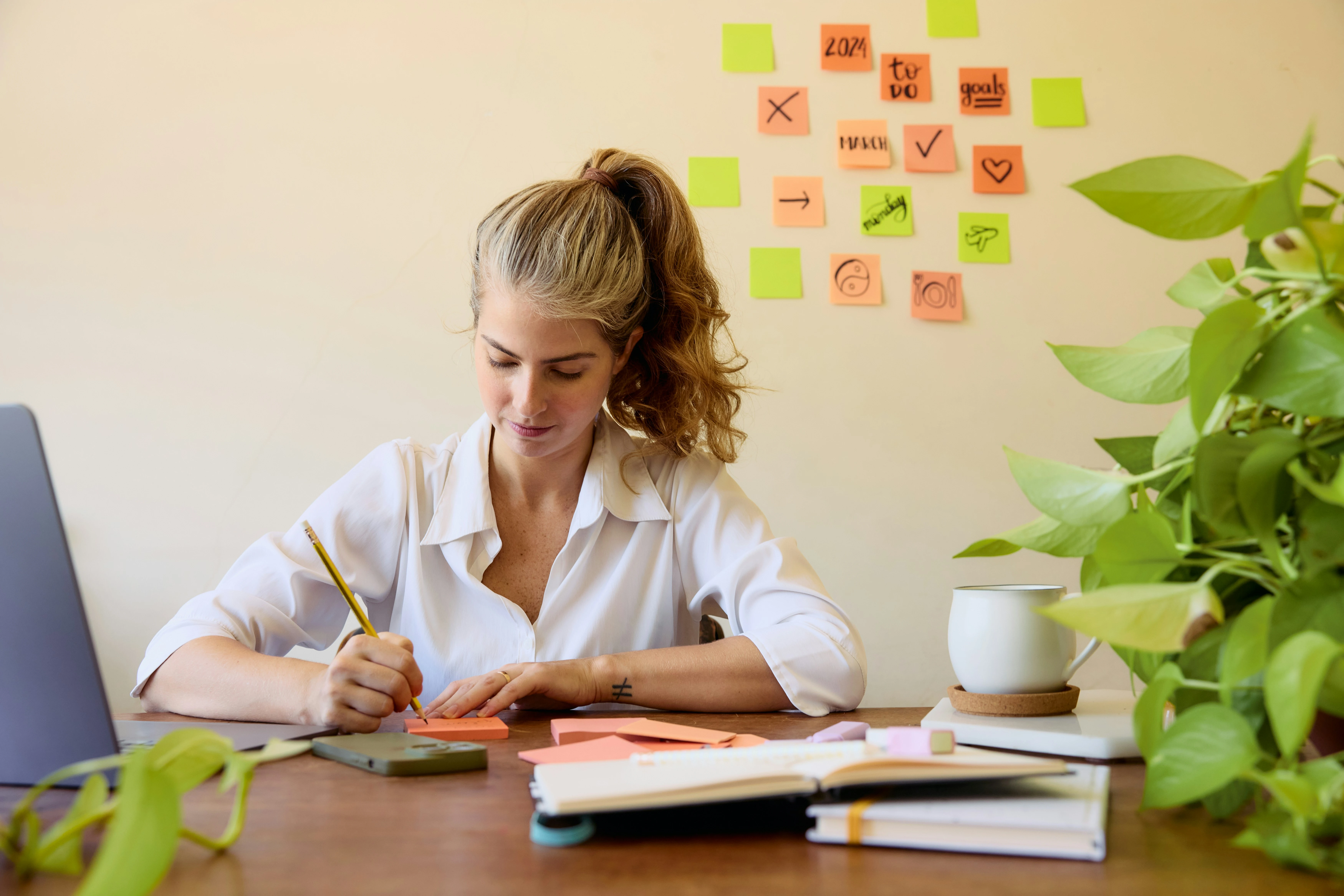 Woman sitting at a desk in a family home doing PA work