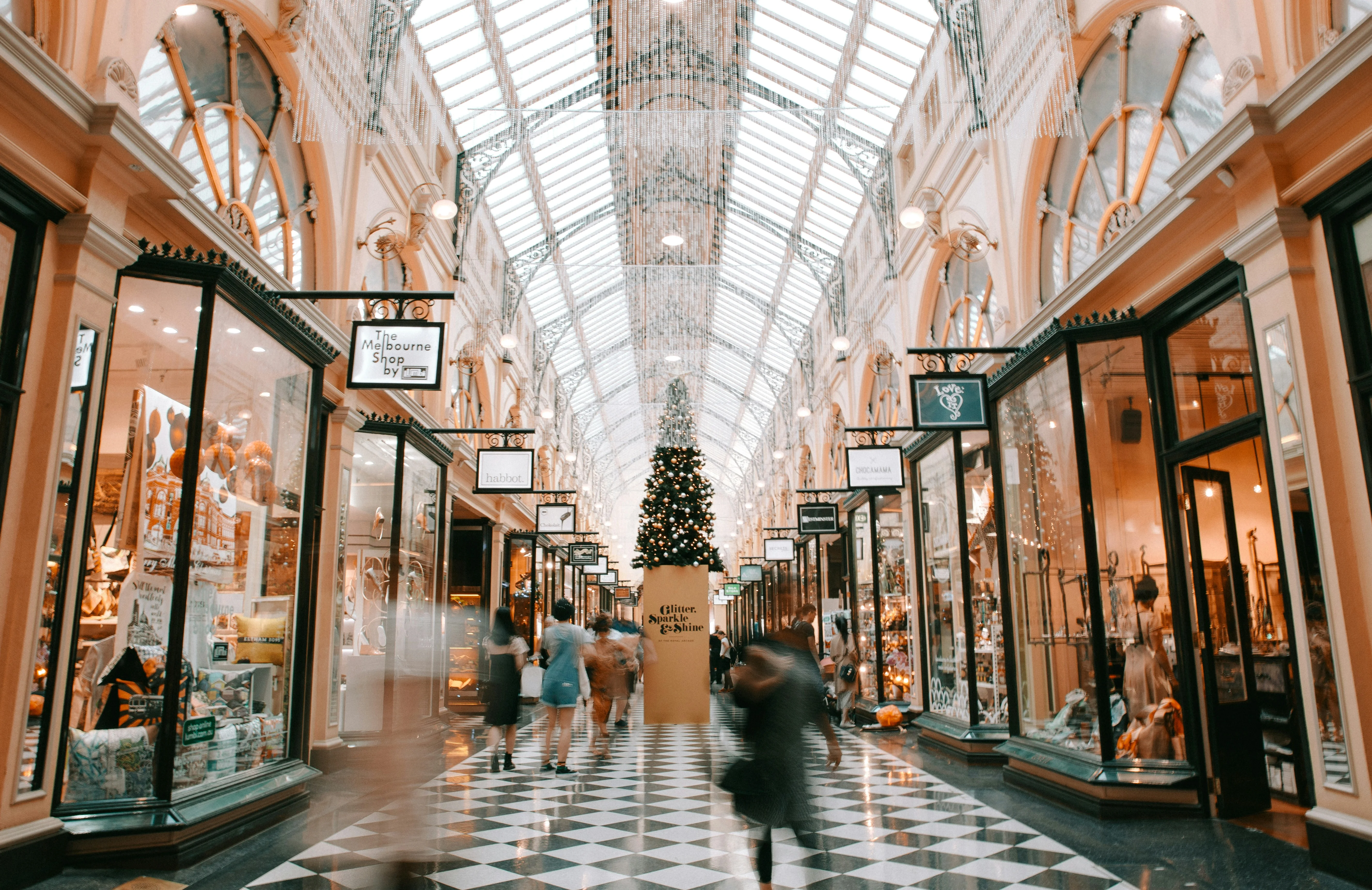 A busy shopping mall at Christmastime, with many retailers advertising Christmas temp jobs.