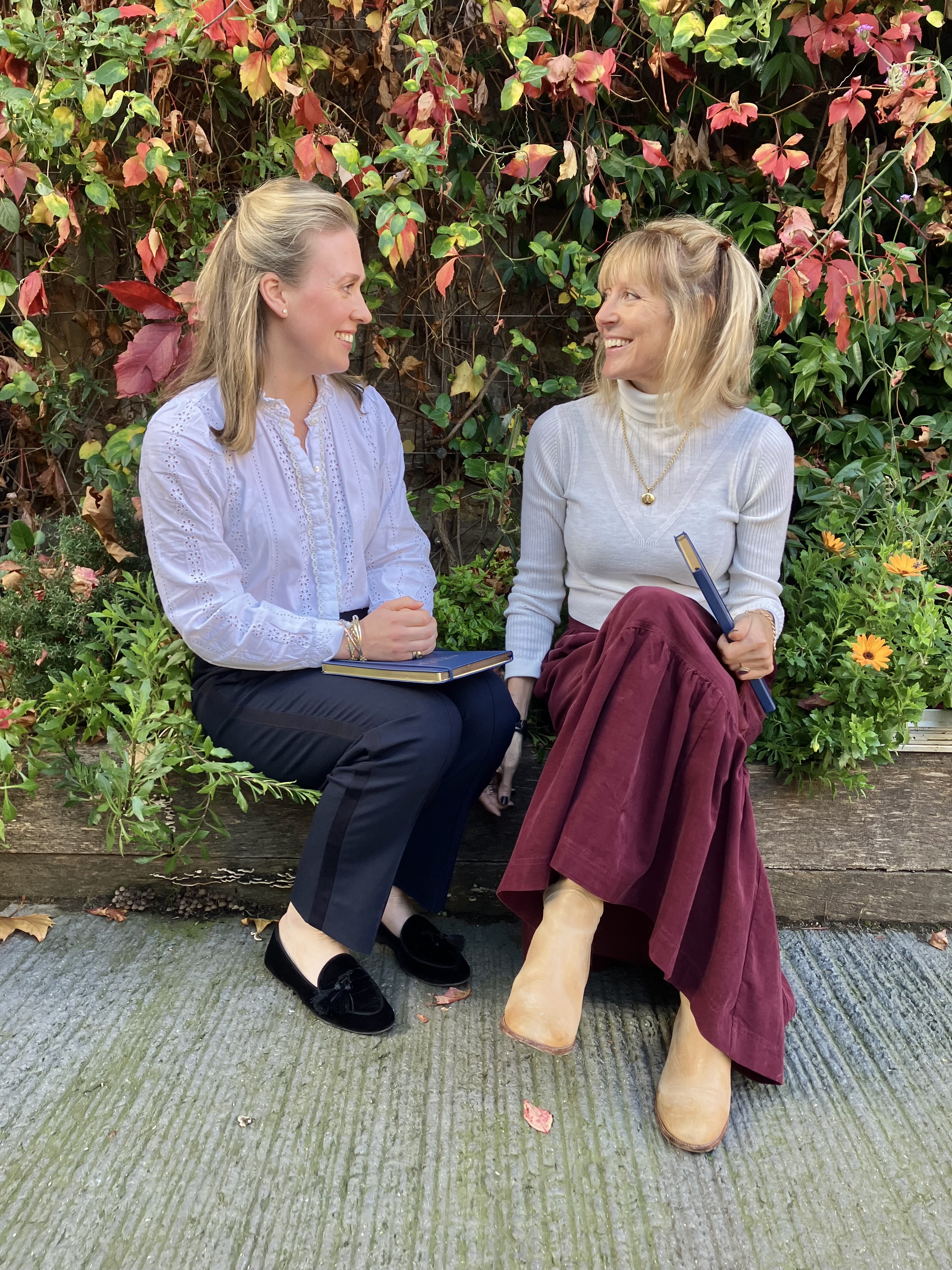 Olivia Coughtrie and Auria Heanley sat outside at their temporary staffing agency in London.